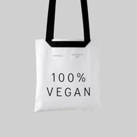 Load image into Gallery viewer, A studio shot of the 100% Vegan Tote in white canvas against a light grey background. The bag features "100% VEGAN" printed in bold black letters, along with the Superegg logo and "Hatched in NYC" text, showcasing a minimalist and sustainable carryall.