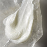 Load image into Gallery viewer, A detailed texture swatch of the Gentle Elements Cleansing Foam. The image highlights the rich, milky, and pearlescent cream consistency of the cleanser, which transforms into a low-foaming lather to purify and soften the skin.