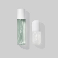 Load image into Gallery viewer, A clean studio shot of the Biome Barrier Duo featuring the Kind Atmosphere Biome Mist and Tonal Scenery Reparative Serum. The two minimalist bottles are displayed against a soft grey background with gentle shadows, highlighting this essential pairing for skin barrier strength.