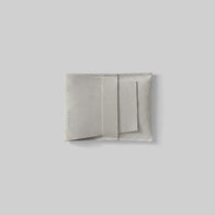 Load image into Gallery viewer, A light gray microfiber protective pouch for the Superegg Flow Egg Sculpting Gua Sha, featuring the debossed SUPEREGG NYC logo on a minimalist light gray background.