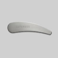 Load image into Gallery viewer, A top-down view of the silver stainless steel Superegg Precision Egg Skincare Spatula featuring an engraved logo, displayed on a minimalist light gray background.