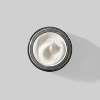 Load image into Gallery viewer, A top-down view of an open jar of Superegg Soft Strength Rich Resilience Cream, revealing its thick, whipped white velvety texture inside a sleek gunmetal silver container.