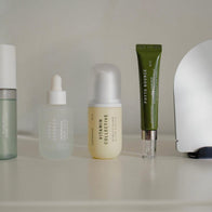Load image into Gallery viewer, A lineup of Superegg products on a white surface, including the Kind Atmosphere Biome Mist, Tonal Scenery Reparative Serum, Vitamin Collective Vitality Elixir, and Phyto Bounce Eye Contour, showcasing the brand's cohesive and minimalist packaging design.